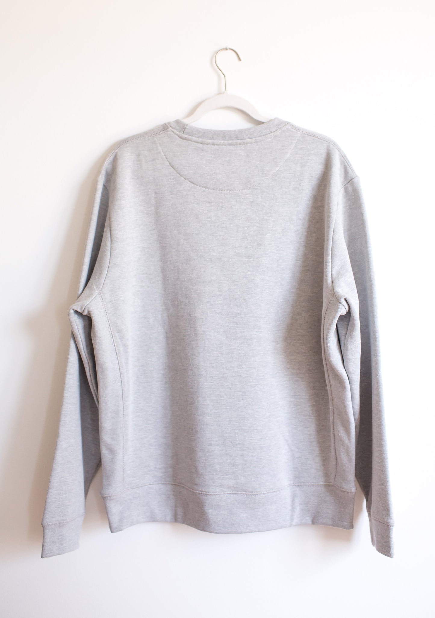 Back of hanging heather grey crewneck sweatshirt.