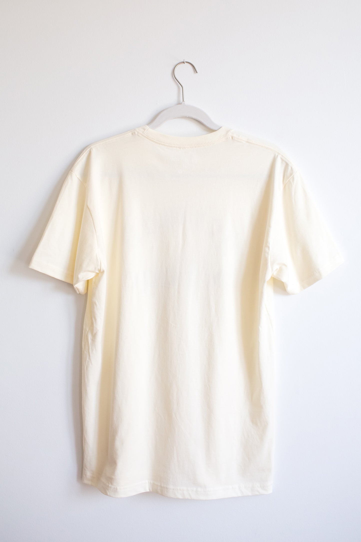 Back of cream colored cotton crewneck tee