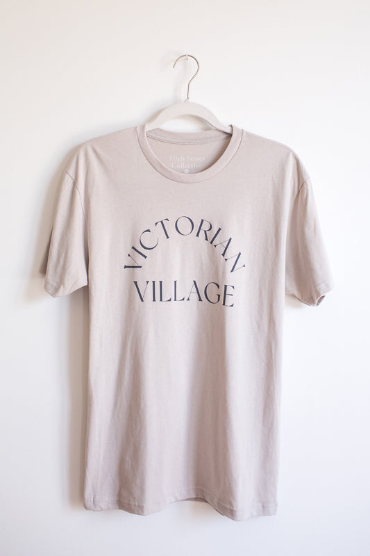 Hanging light grey sueded tee with Victorian Village graphic on front.