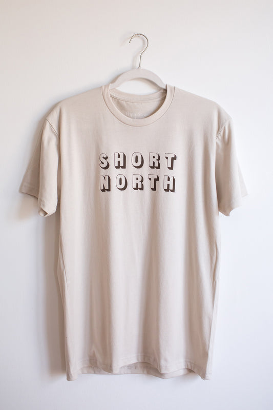 Sand colored sueded crewneck tee with cocoa colored Short North graphic at front.