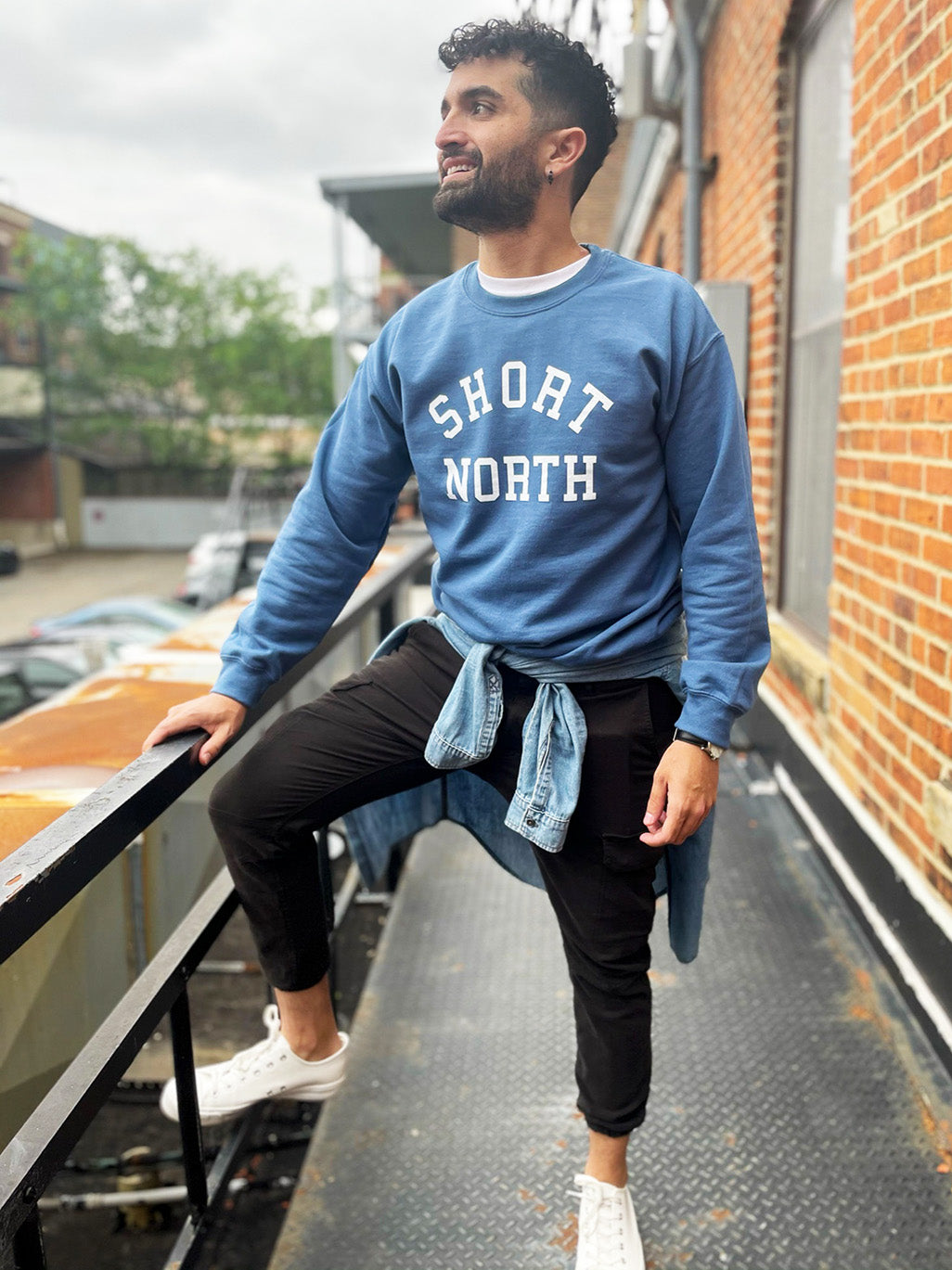 Model wearing indigo blue Short North crewneck sweatshirt.