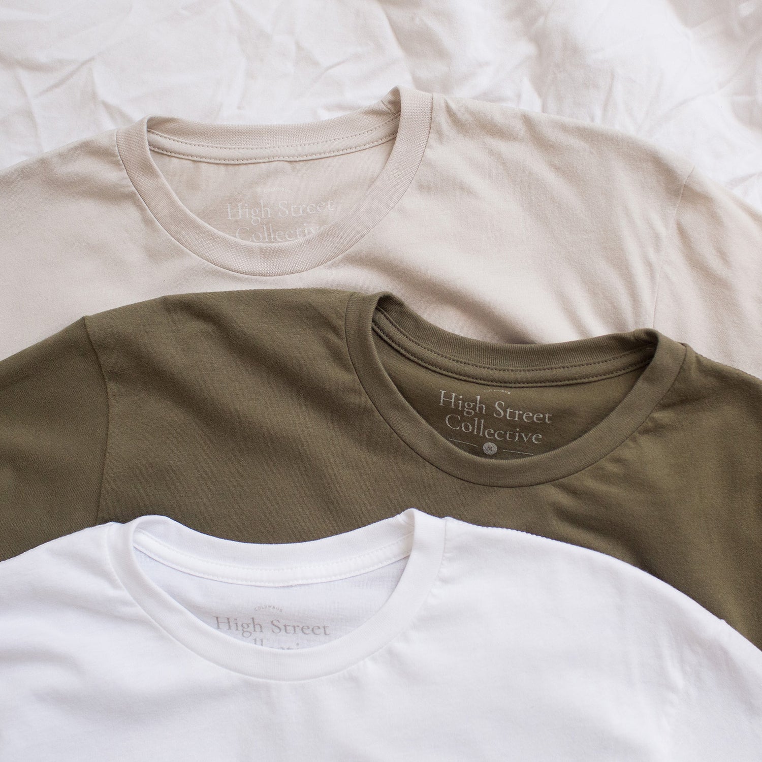 Three neutral colored tees layered together