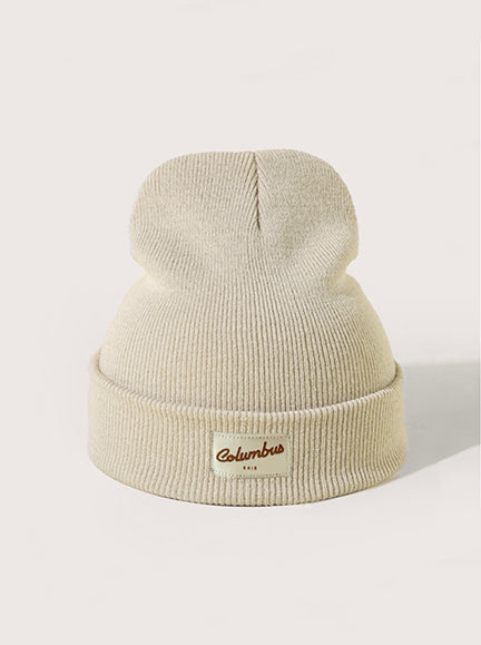 Oatmeal cuffed knit beanie with Columbus, Ohio patch at center front.