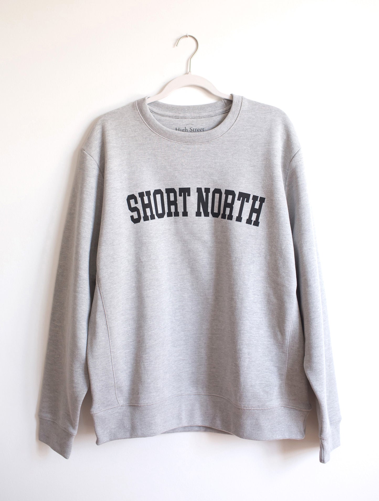 Heather grey cotton crewneck sweatshirt with black Short North graphic at front.