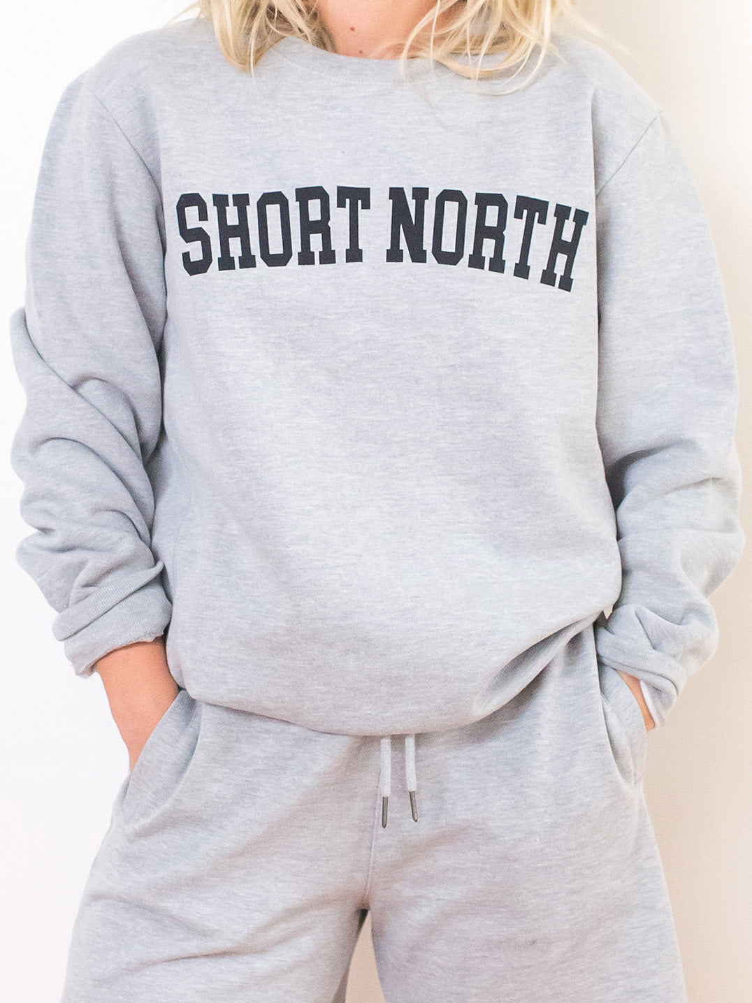 Model wearing premium heather grey crewneck sweatshirt with Short North Columbus, Ohio graphic at front