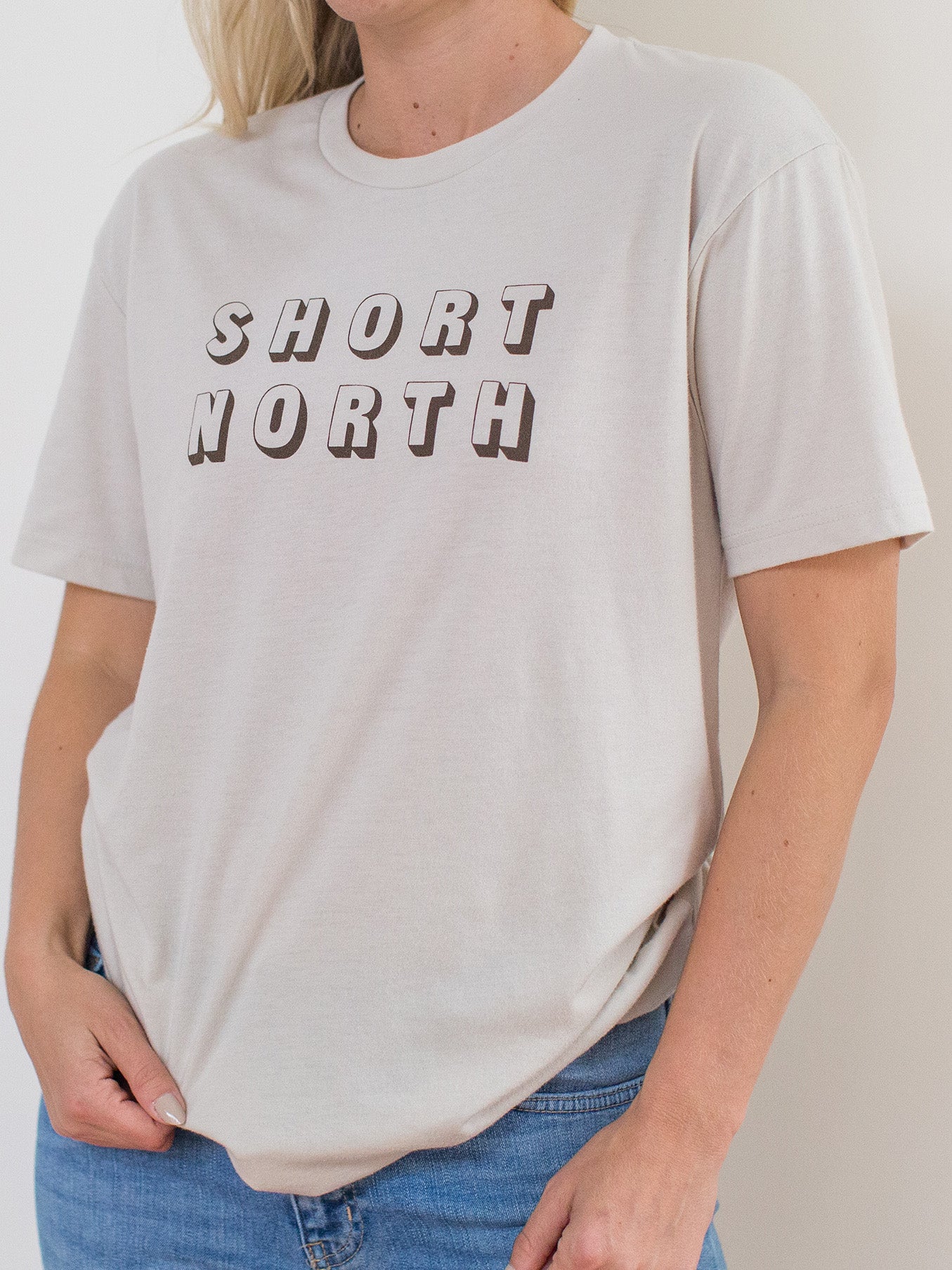 Model wearing sand colored sueded crewneck tee with Short North Columbus, Ohio graphic at front